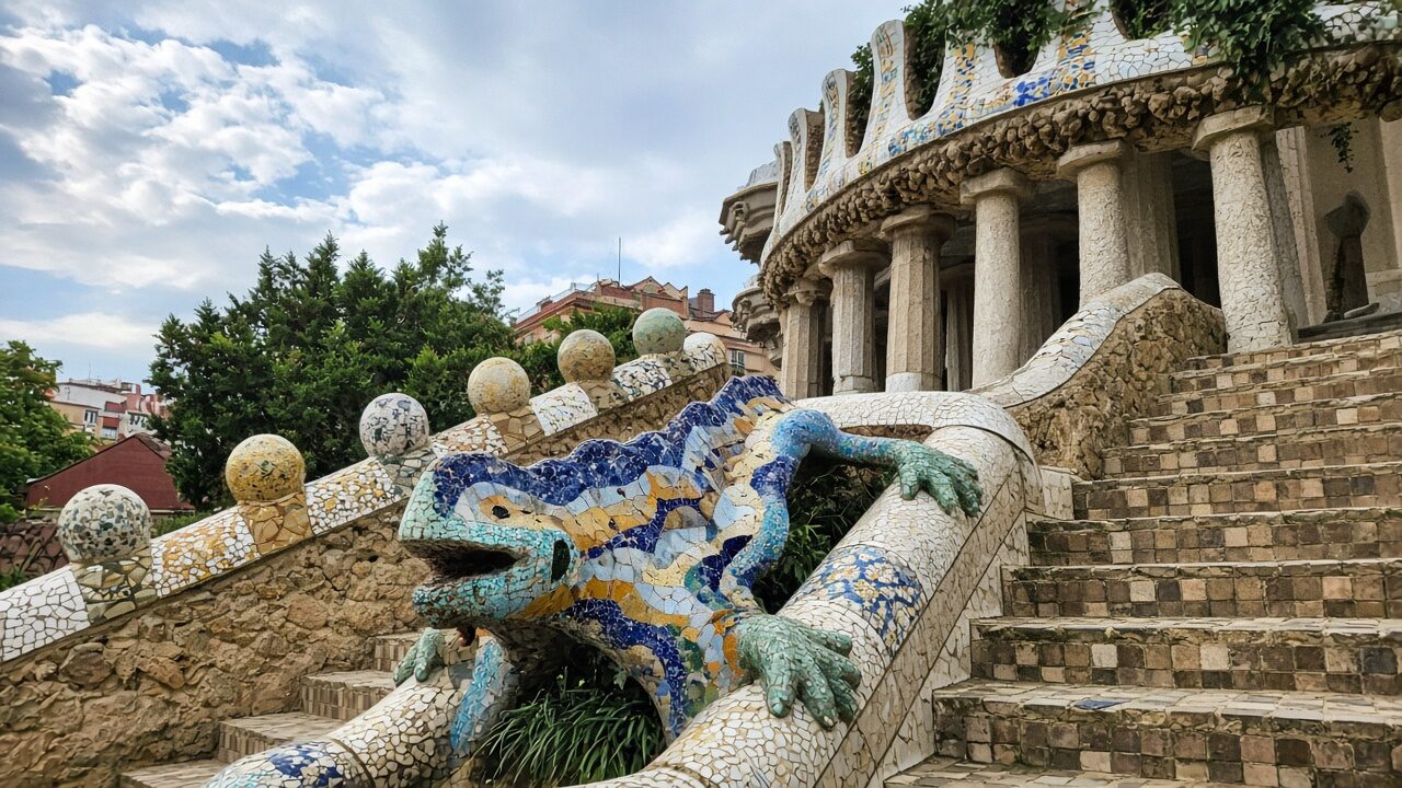 Mosaic salamander on Park Güell stairs — tourist phone photo