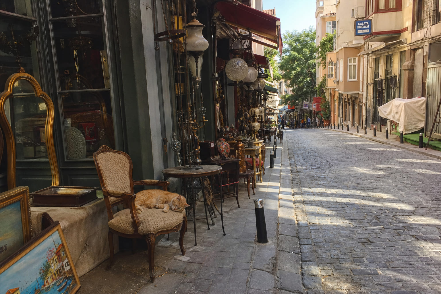 Narrow cobblestone street in Çukurcuma, Istanbul: vintage furniture outside antique shops, casual smartphone travel photo
