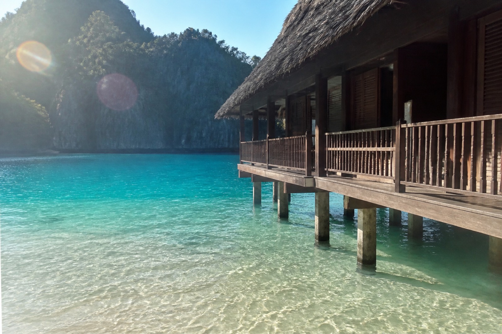 Overwater villa on stilts above a turquoise Palawan lagoon — casual tourist phone photo