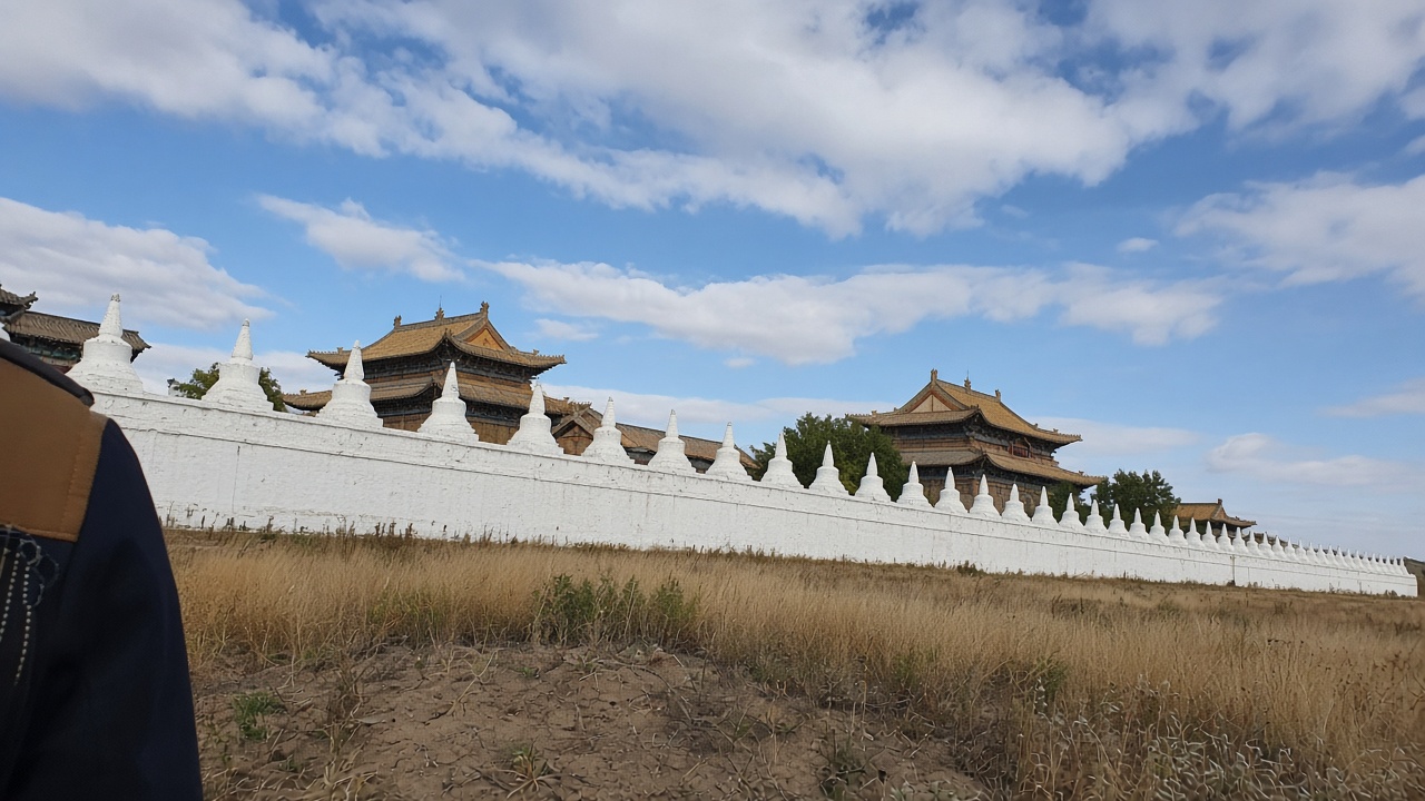 Phone photo of the Erdene Zuu wall: white stupas and tiled roofs in Kharkhorin