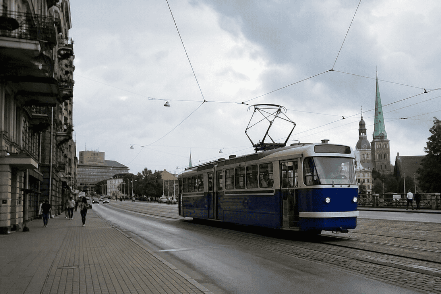 Phone snapshot: a red tram on a sunny Riga street