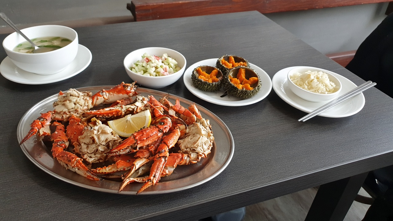 Boiled Sakhalin crab on a casual restaurant table — tourist phone photo