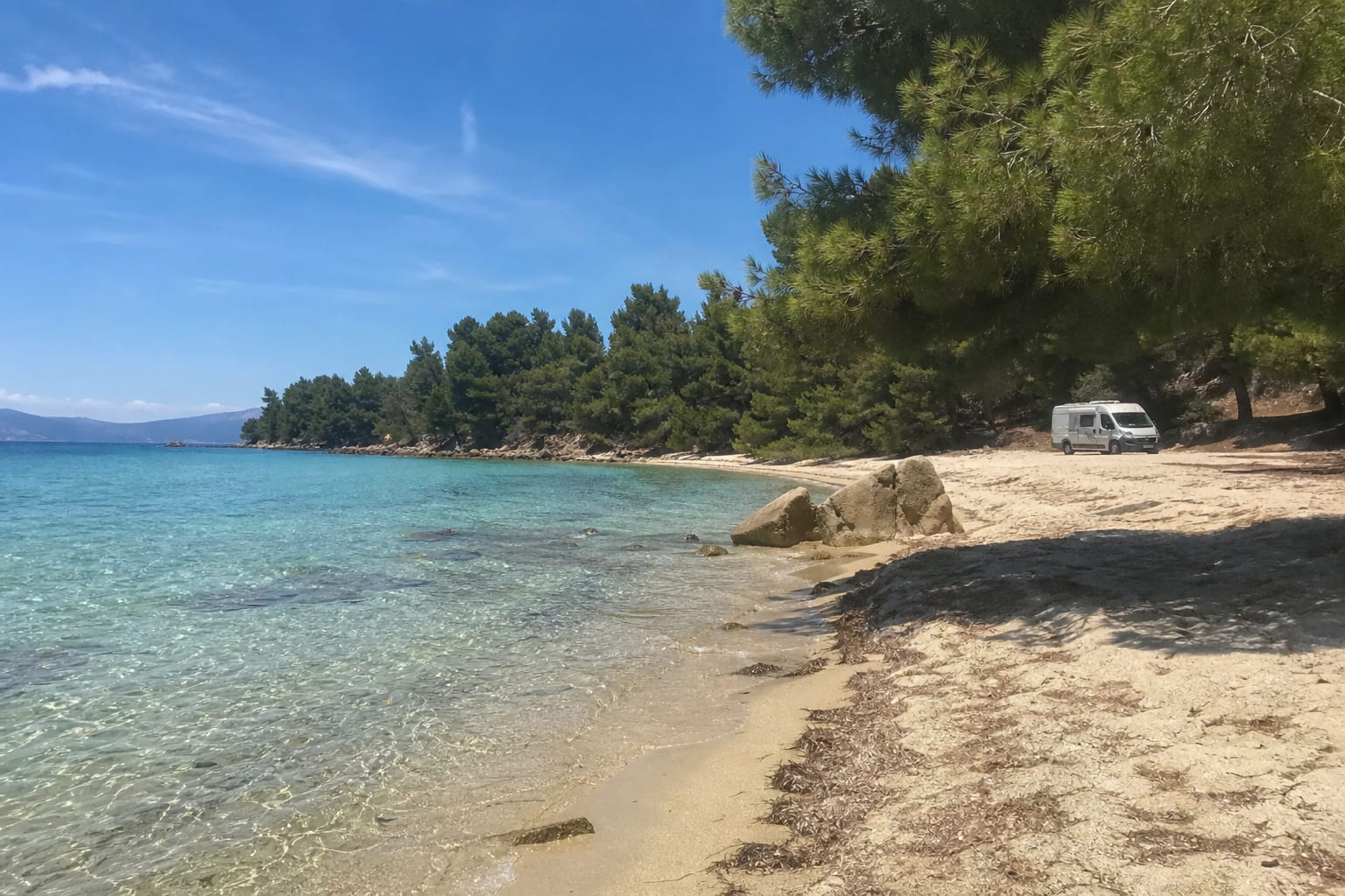 Wild sandy Azapiko Beach in Sithonia — casual smartphone travel photo, pine trees at turquoise water