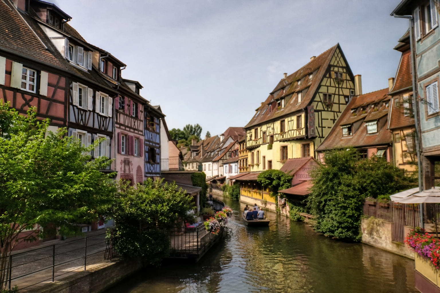 Tourist phone photo of half-timbered houses along a canal in a small European town like Colmar