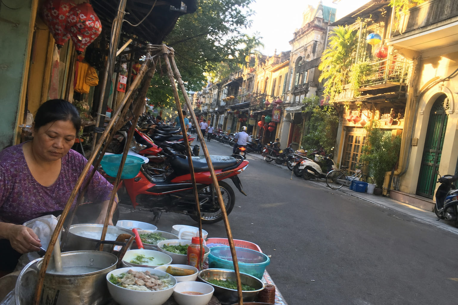 Hanoi Old Quarter street with motorbikes and street food — casual phone photo by a tourist in Vietnam