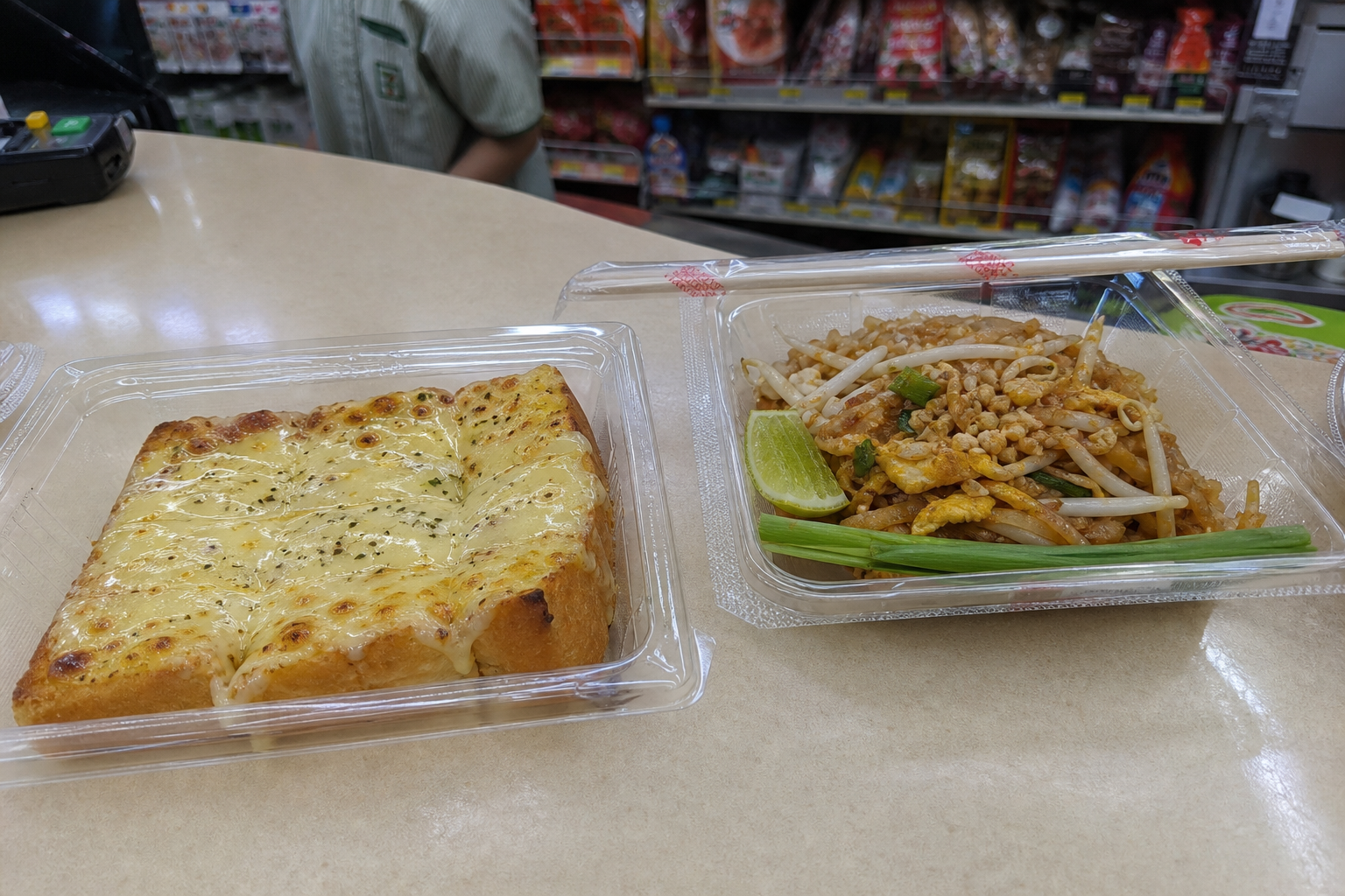 Hot toast and pad thai at a Thai 7-Eleven — smartphone travel photo