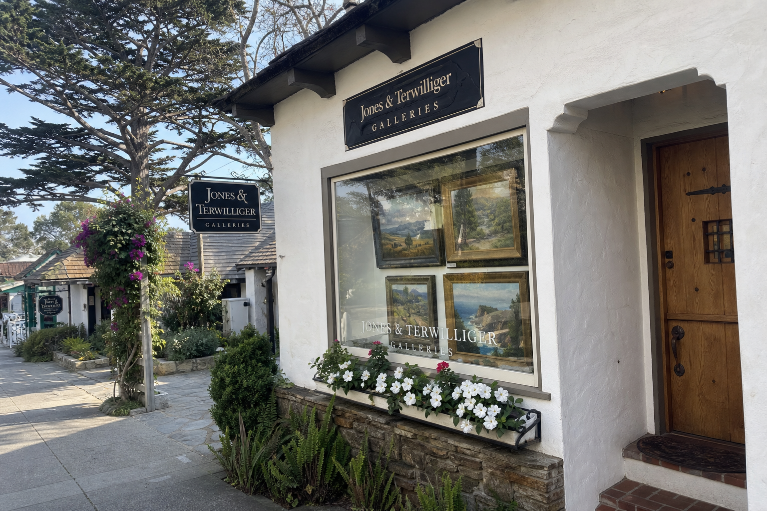 Tourist phone photo: white stucco art gallery facade with flower boxes on Ocean Avenue in Carmel-by-the-Sea