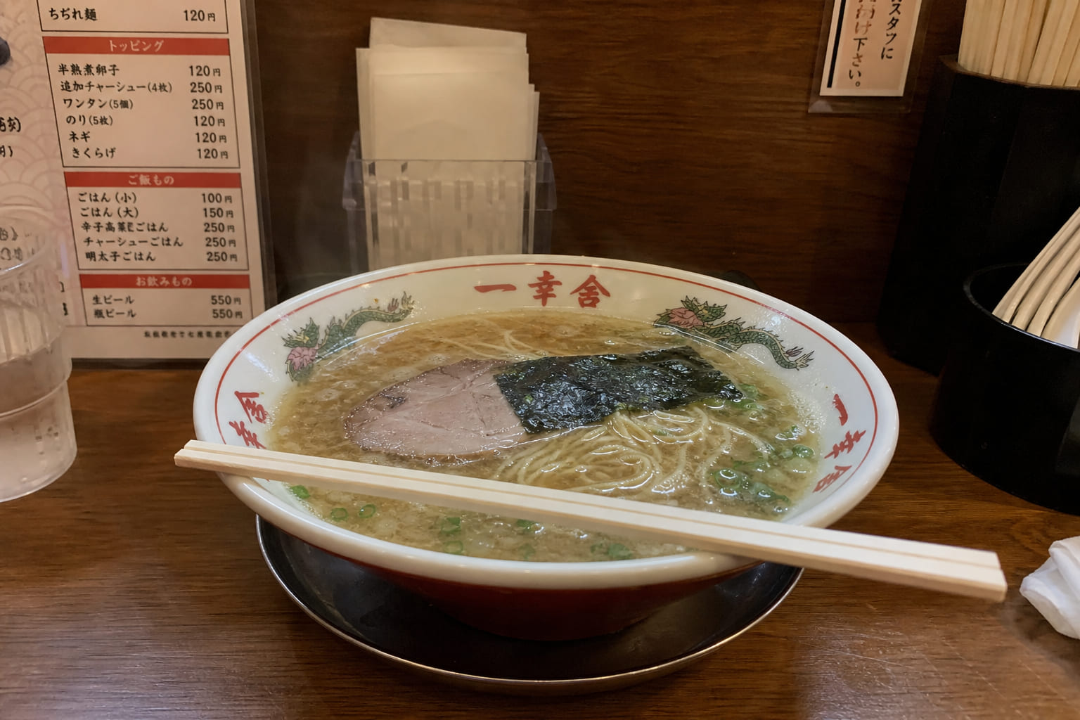 Cheap Michelin eats in Asia — casual tourist phone shot Tourist phone photo of a steaming ramen bowl at a small Tokyo counter — typical affordable Michelin format