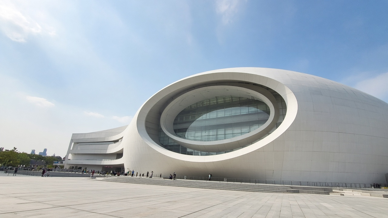 Shanghai Astronomy Museum exterior — tourist phone photo of the oculus façade in Lingang
