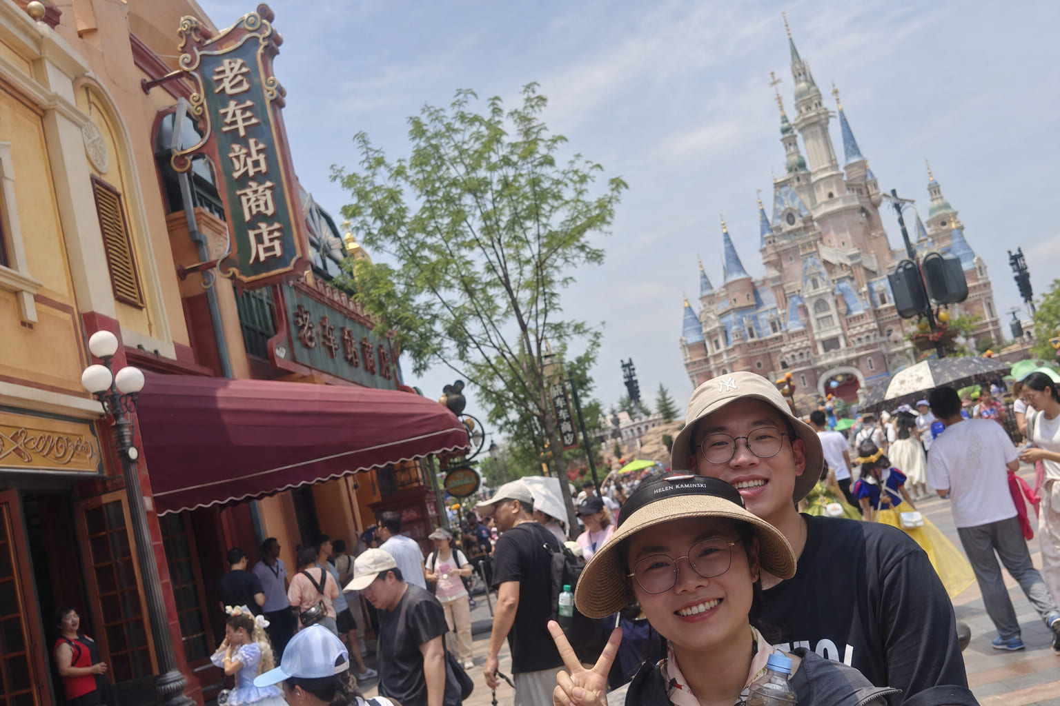 Shanghai Disneyland castle and themed streets — tourist smartphone photo