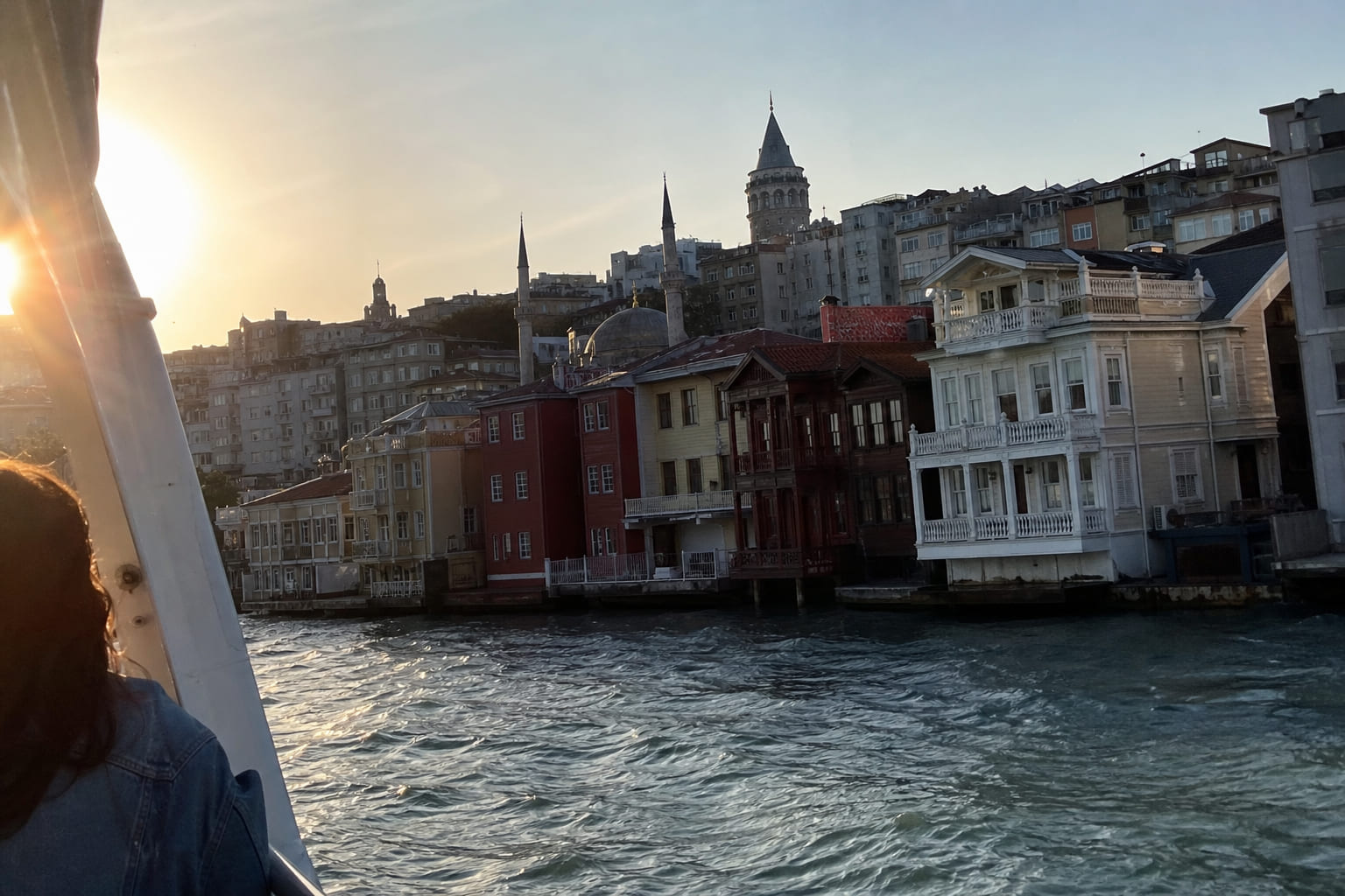 Casual phone photo of Ottoman yalı mansions on the Bosphorus in Istanbul, taken from a ferry