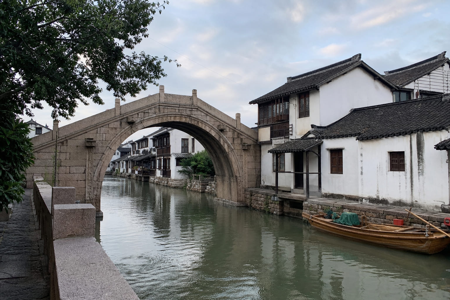 Zhujiajiao water town near Shanghai — canal, stone bridge and boat, casual tourist phone photo